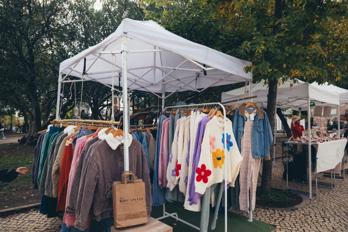 Illustrative photo: vintage clothes rails under a market gazebo